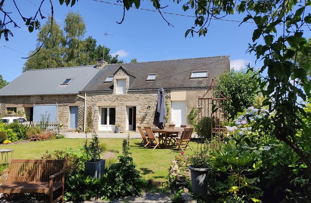 Country house on the edge of a forest with landscaped garden.