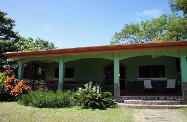 Cozy 3-bedroom retreat in Tierra Pacifica with lush gardens, AC, hammock rancho, and full access to pool, gym, yoga room, and more.
