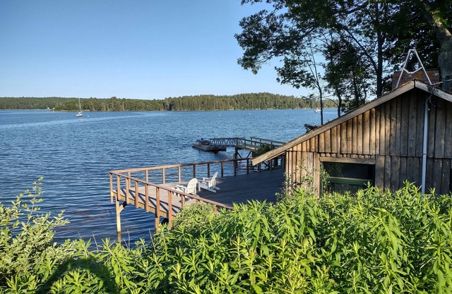 Cozy waterfront log cottage with huge outdoor living area.