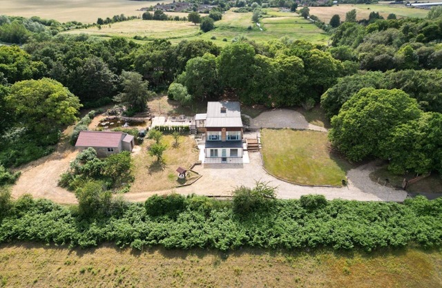 Detached property in woodland surrounding.