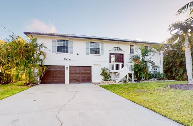 Dog-friendly waterfront home with extensive deck, canal views, lawn, W/D, AC