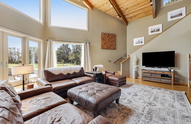 Enjoy a private hot tub, deck, distant ocean view, fireplace, and pool