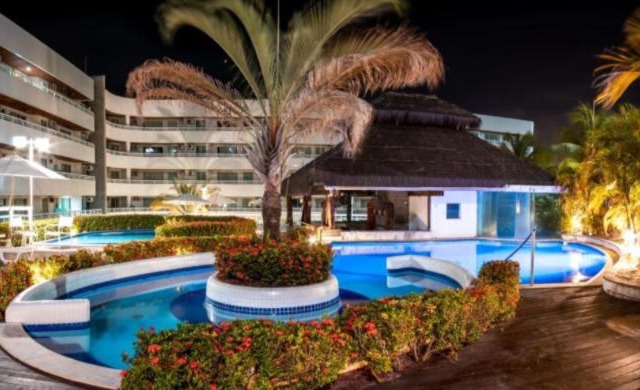 Flat no Blue Marlin Resort Com linda vista do jardim por Carpediem