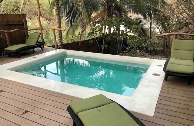 Great room with deck pool in front of perfect bay