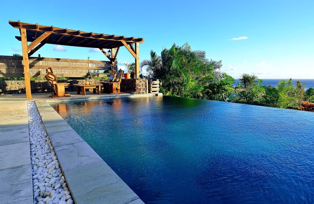 House facing the ocean, idyllic setting.