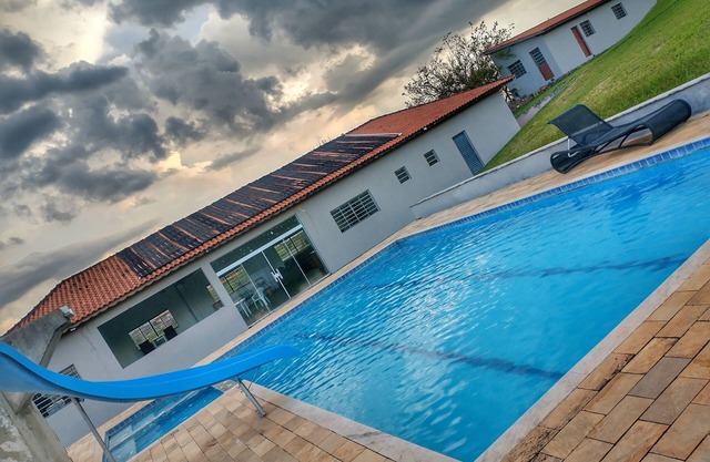 Huge farm with pool, game room and lots of green.
