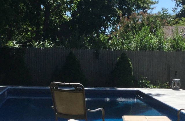 Immaculate Bellport village cottage vacation home w/ Pool, Hot Tub, bikes & Maid