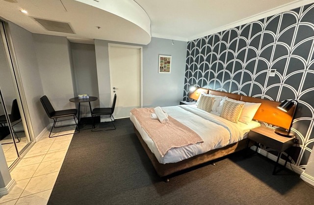 KozyGuru | CBD Queen Bed Studio Cozy and Convenient