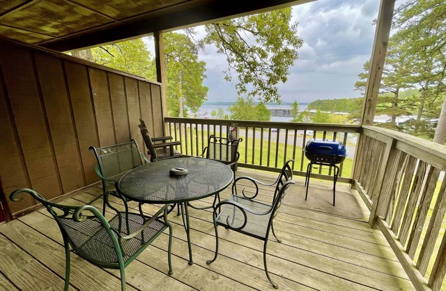 Lake view queen guest room with two queens, sleeper sofa and patio overlooking Lake Ouachita. by RedAwning