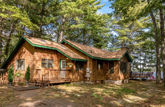 Lakefront home in a great location with docks, private beach, sauna & firepit