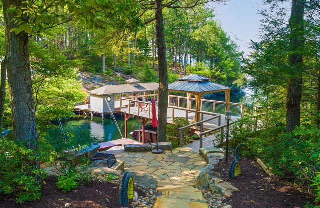 Lakefront home with granite counters, fireplace, lake views, & dock