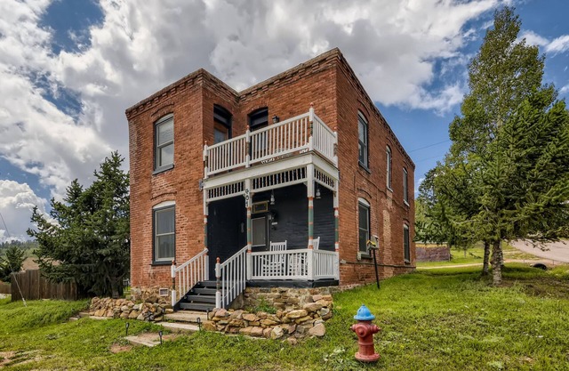 Landmark home built in 1895 with porches, office & western-themed decor
