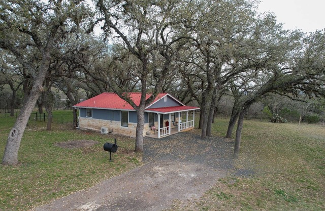 Live Oak Cottage on a beautiful lot with large oak trees and fenced backyard.