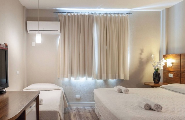 Luxurious Executive Triple Room Steps from Curitiba’s Best Parks and Landmark