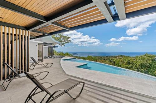 Luxurious Ultramodern Property with Private Suites, Infinity Pool, and Sweeping Ocean and Mountain Views