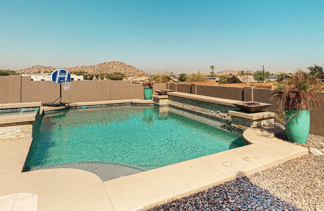 Luxury home with a pool, spa, fireplace, & private gas grill