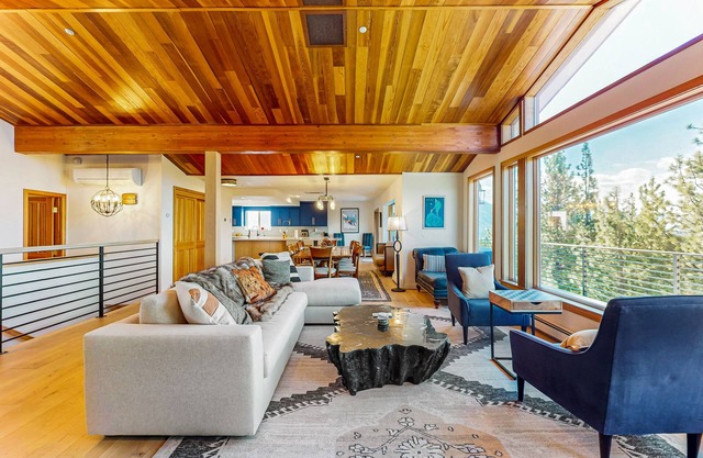 Luxury lake-view home with spacious deck, sauna, golf room, & wet bar