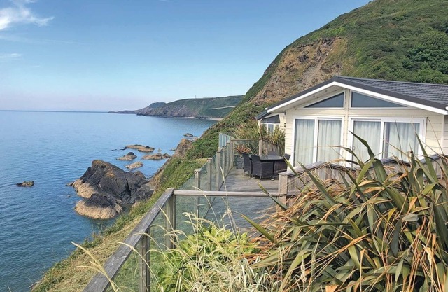 Luxury lodge with two doubles, one with en suite shower and one twin.