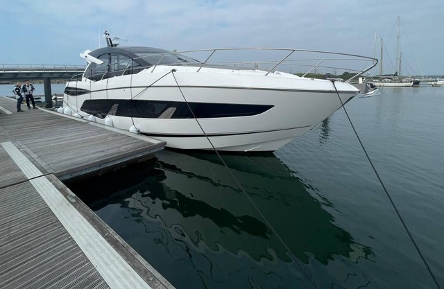 Luxury yacht moored in a tranquil marina setting