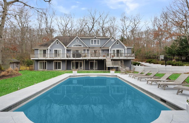 Majestic estate on over one acre of lush land, beautiful landscaping,.