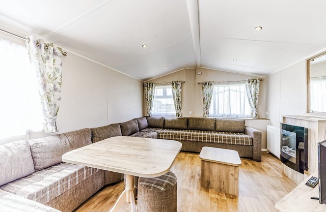 Modern and contemporary 12ft-wide caravan with one double and two twin.