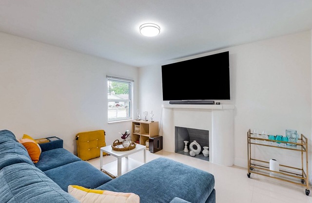 Modern charmer with wood fireplace, central location, & AC