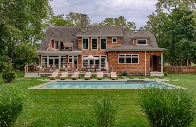 Modern Coastal Farmhouse style home with a private pool, open-floor plan,.