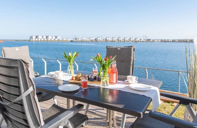 Modern ground floor apartment with direct water view, terrace and WiFi