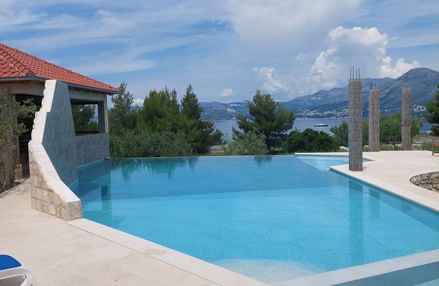 Modern stone villa with infinity pool.