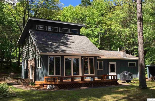 Northwoods lake home with gentle slope to clear lake with sandy beach