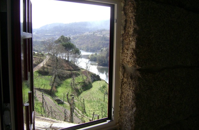 Old stone house with swimming pool and river.