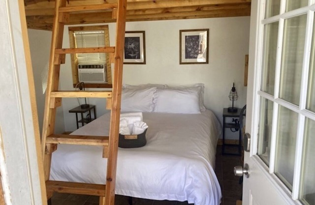 One room camping cabin Double bed on the main level and two lofted twin-size beds Heating and cooling Sleeps: 4 Pets: 2 Parking: 1