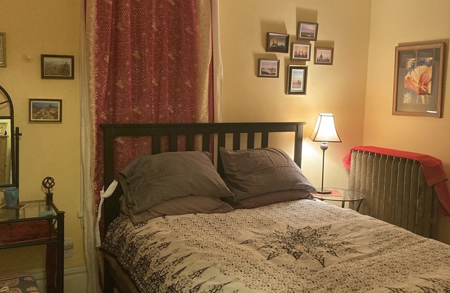 Private room in shared home with full kitchen, living room, and yoga space.