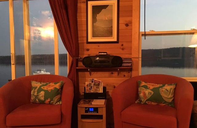 Private self contained cottage with terraced decking right to the water.