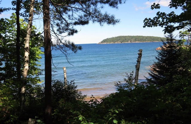 Quiet, isolated oasis on 300 feet of Lake Superior beach and 10 wooded acres.