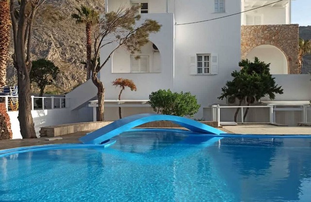 Relaxing environment under trees with a swimming pool, a pool bar.