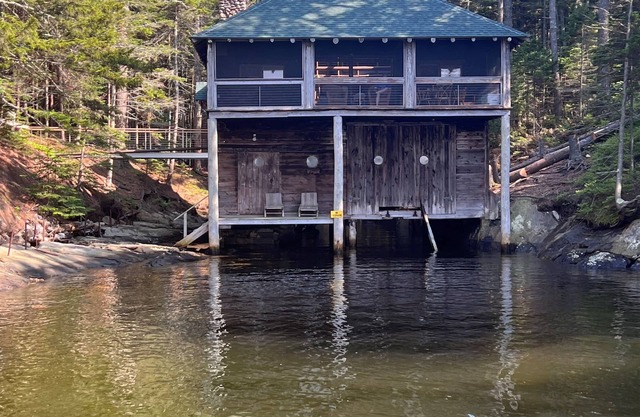 Renovated 3-BR boathouse built atop water in quiet cove; private float & trails