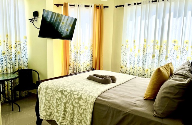 Romantic Hispanic 304 private room with refrigerator and dining area.