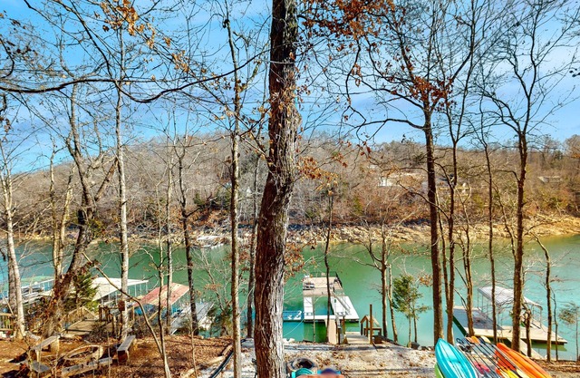 Rustic lakefront retreat with a hot tub, double-deck dock, firepit, grill & deck