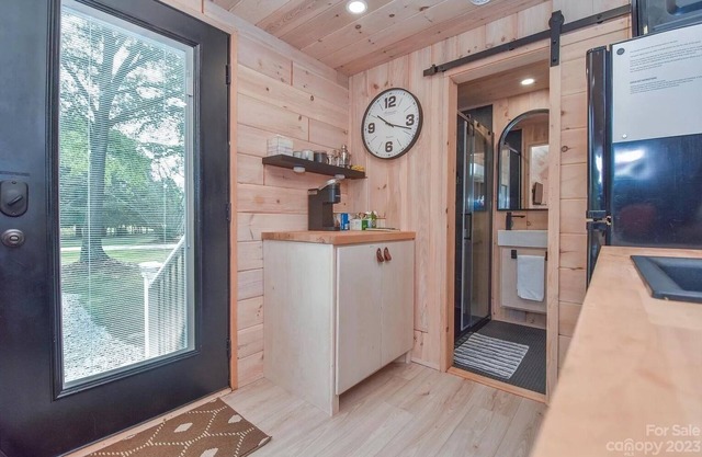 Scandinavian tiny home surrounded by nature with patio, solo fire pit, grill.