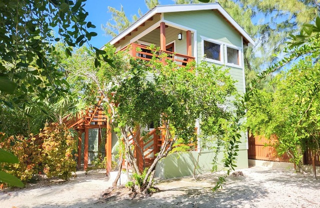 Scenic retreat on the beach with a balcony - pool, grill, dock, and canoe access