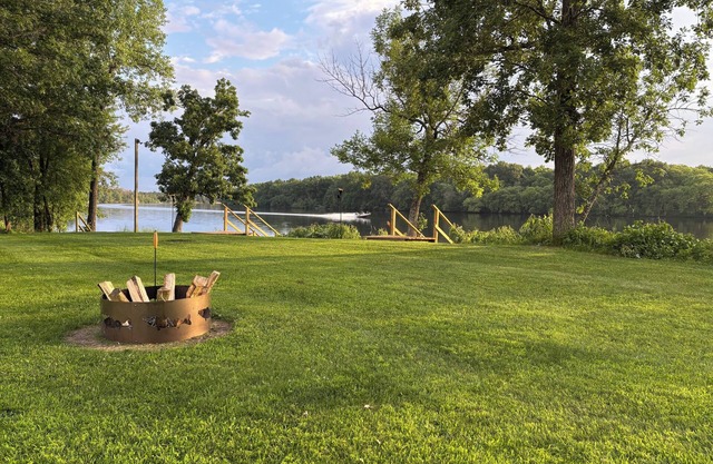 Scenic riverfront cottage with boat landing and docks.