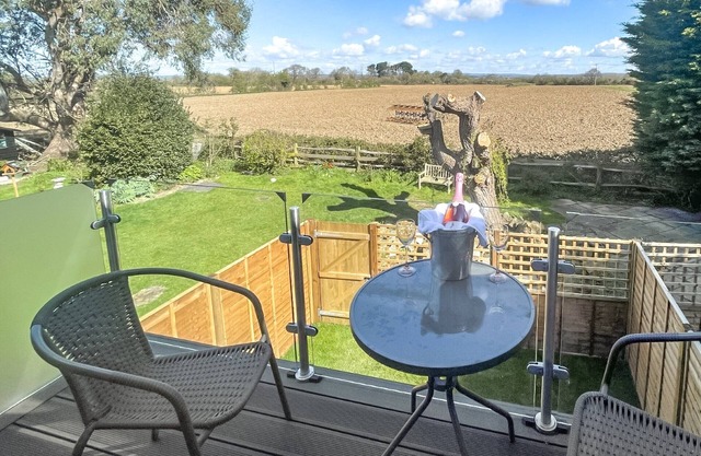 Set in a tranquil location with a balcony overlooking the fields and countryside.