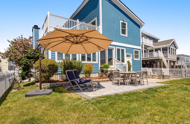 South Bethany Harbor waterfront home with patio, firepit, & roof deck