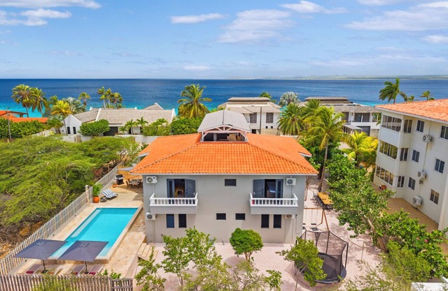 Spacious 5-bedroom villa on Bonaire with private pool, ocean view rooftop terrace, tropical garden, near top kitesurfing & diving spots. Sleeps 10 persons.