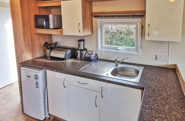 Spacious and well-presented 12ft-wide caravan with one double and two twin bedrooms.
