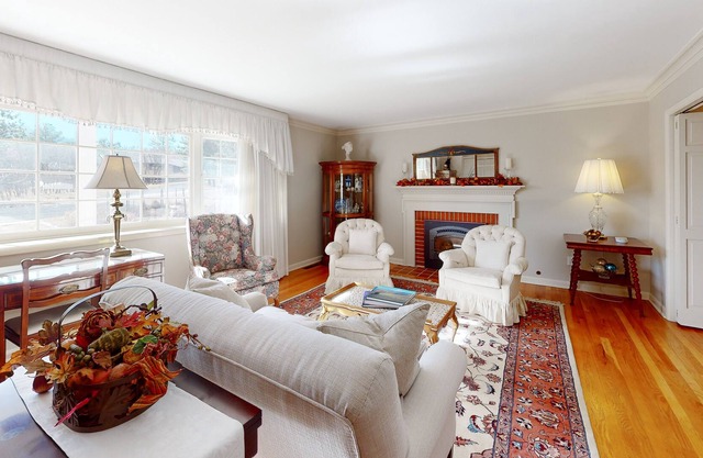 Spacious estate with fenced yard, private pond, outdoor fireplace, & home gym