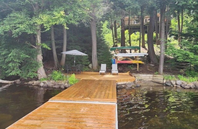 Spacious, waterfront home surrounded by trees with large dock & games room.