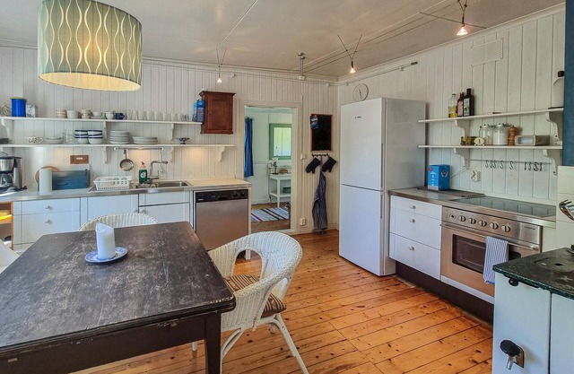 Spend a cosy holiday in this Swedish red holiday home in Färgelanda near several lakes.