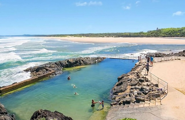 Step out onto the sunny balcony of Peninsula - a spacious beachside home with superb ocean views.